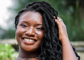 Home Joyful portrait of a smiling African woman with dreadlocks in Nairobi.